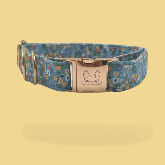 Collar para mascota con herrajes dorados, el collar es color azul con flores.